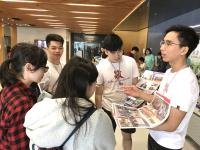 Student ambassadors showing pictures of the College to secondary students during the Academic Planning Day